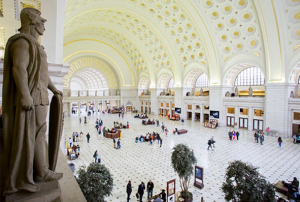 View of a statue overlooking the clean white arched ceilings with gold details in Washington DC's Union Station