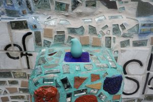 Blue Olika Birdie on a matching blue ledge of mosaic tiles