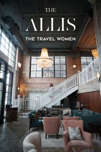 Woman in the middle of the stairs at Soho House Allis entranceway lobby