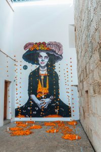 Painting of a woman in Day of the Dead skull makeup