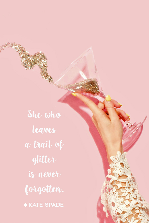 A cocktail in her hand and confetti in her hair.