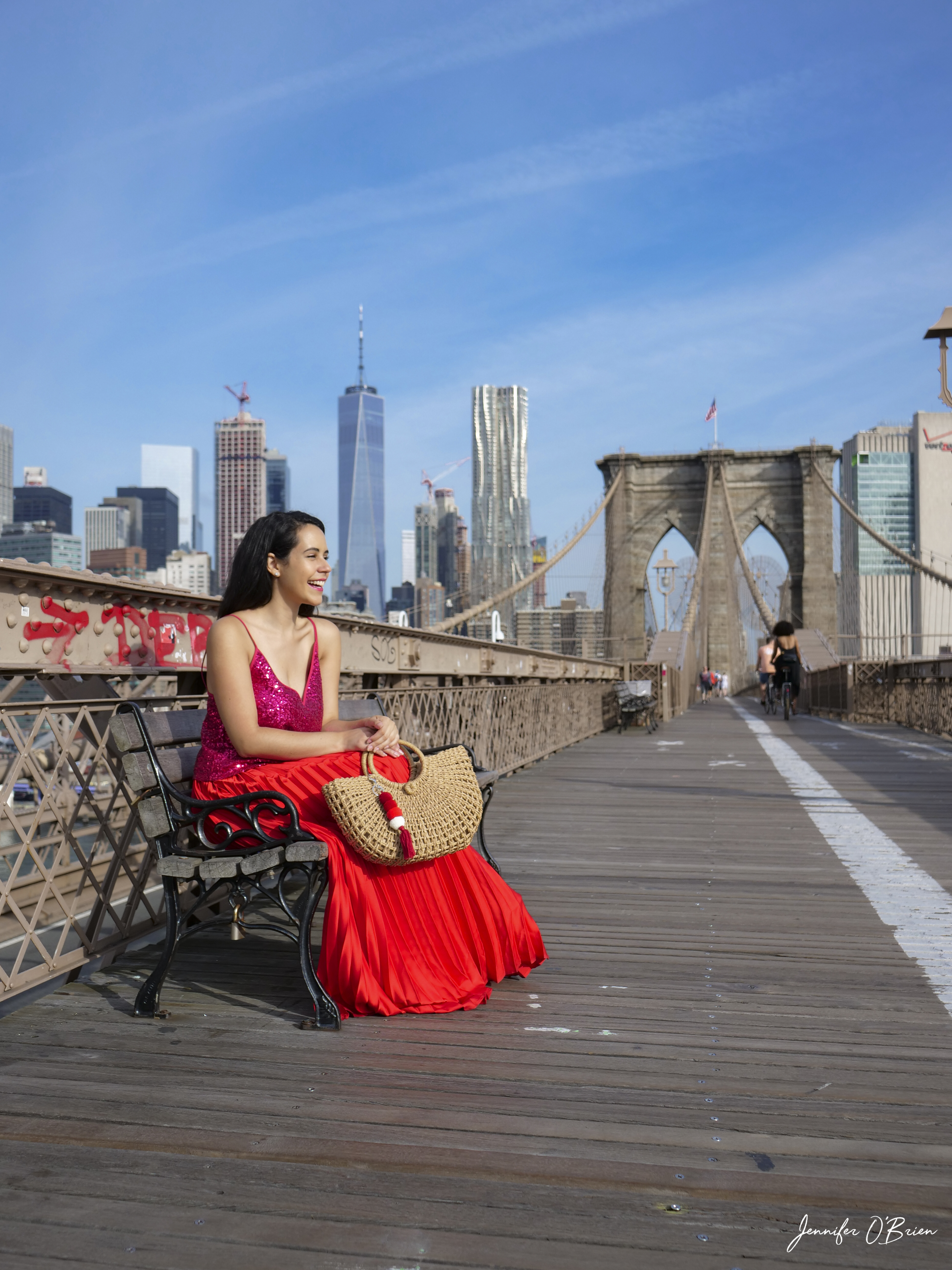 Top Instagram Photos of the Brooklyn Bridge The Travel Women Freedom Tower One World Trade Center sitting on bench red purse and dress matching 