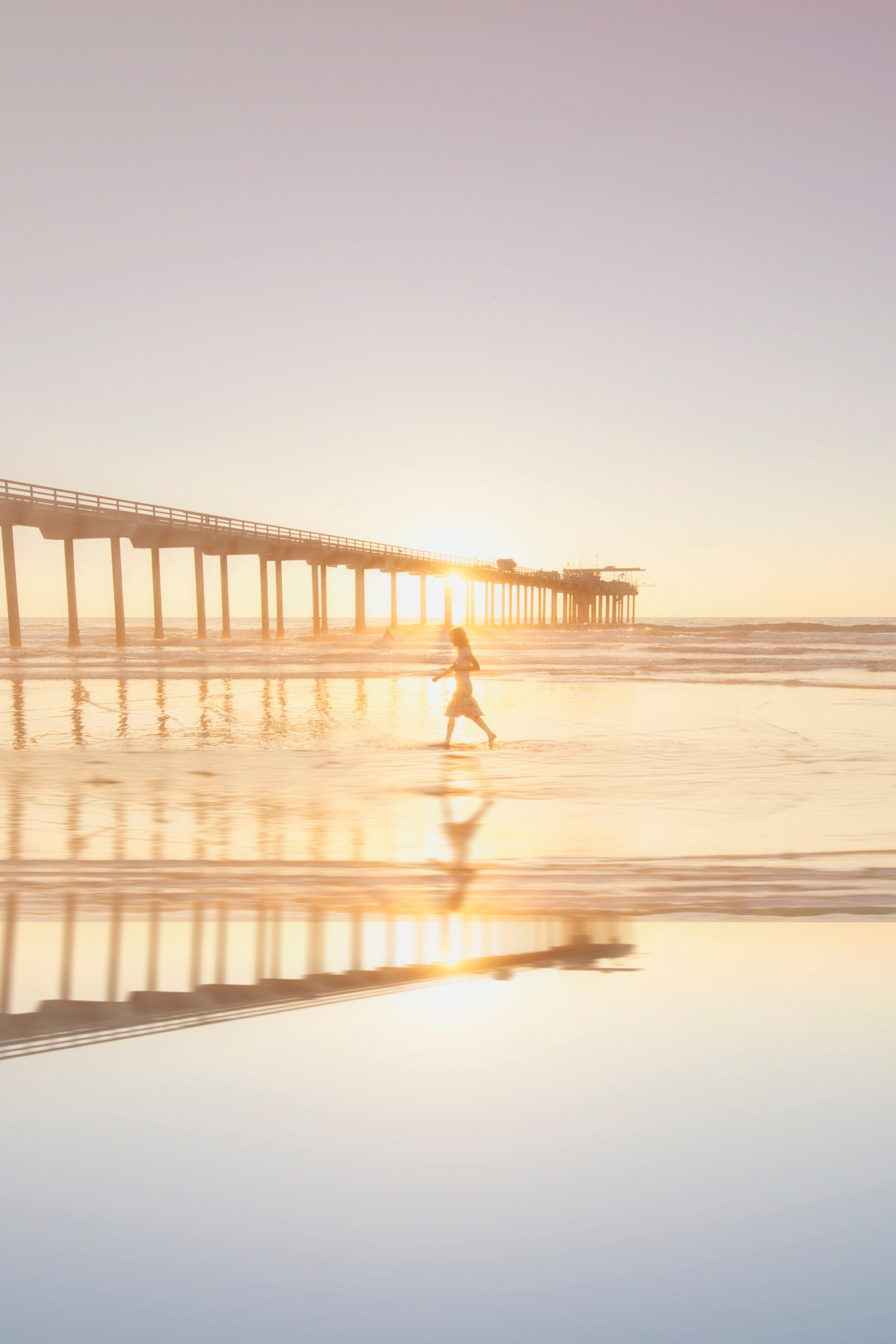 1. San Diego California beach reflections woman girl jumping in front of pier frank-mckenna-7lvjpOWcsOo-unsplash