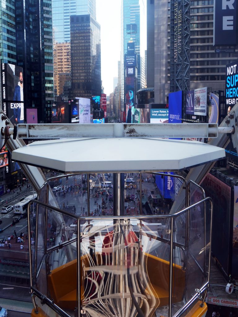 Times Square ferris wheel NYC car with reflections