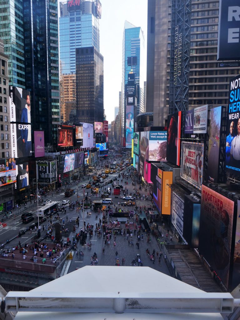 Times Square ferris wheel NYC from inside on the top views of the billboards