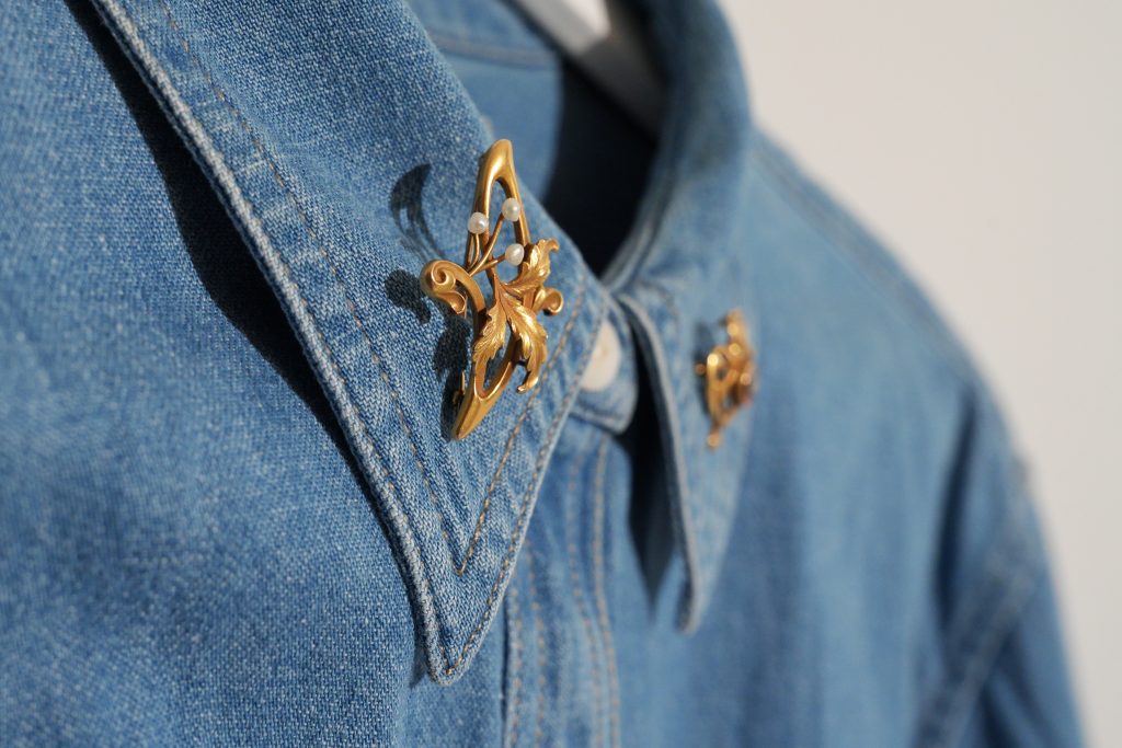 brooch travel gold antique and vintage pins on denim jean shirt jacket collar