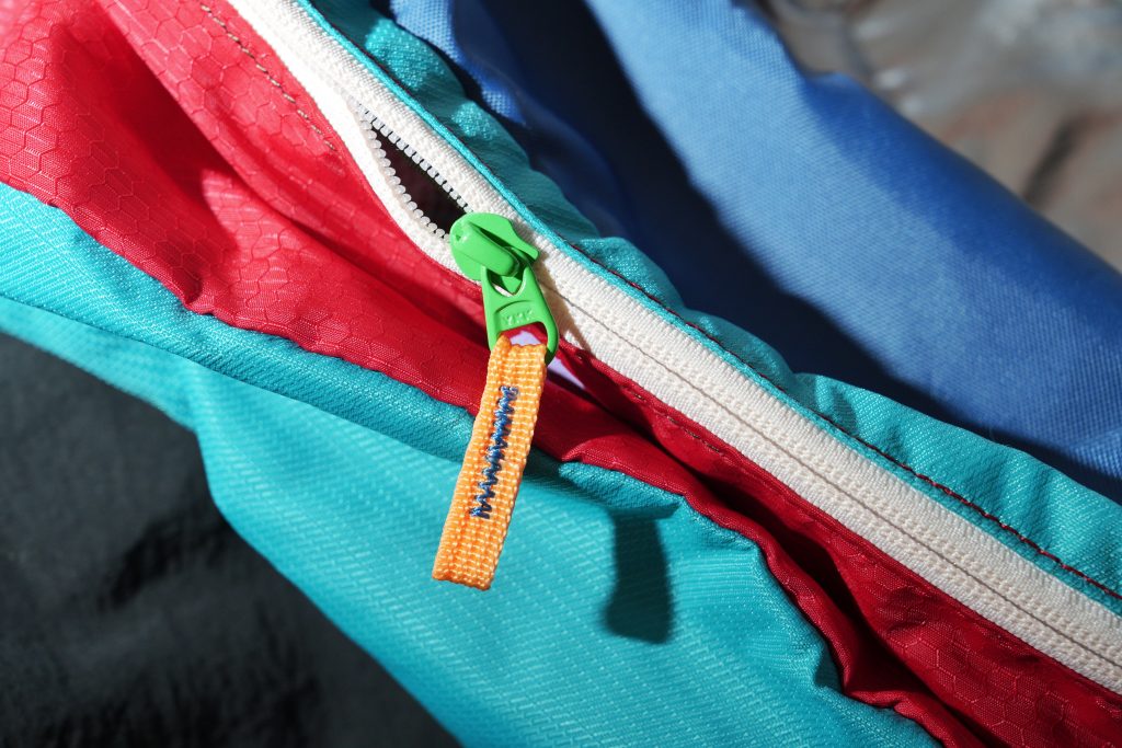 colorful fanny packs cotopaxi zipper green orange blue red Why the Best Bag for Solo Travel is a Fanny Pack