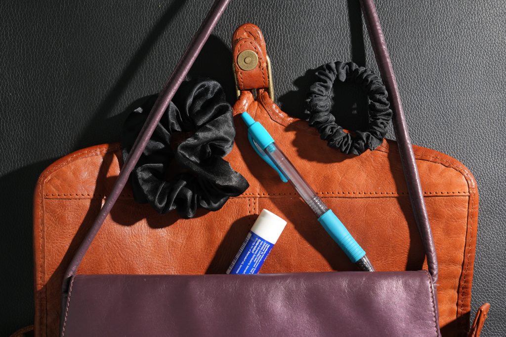 brown and purple purses pen scrunchies lip balm declutter purse before after travel