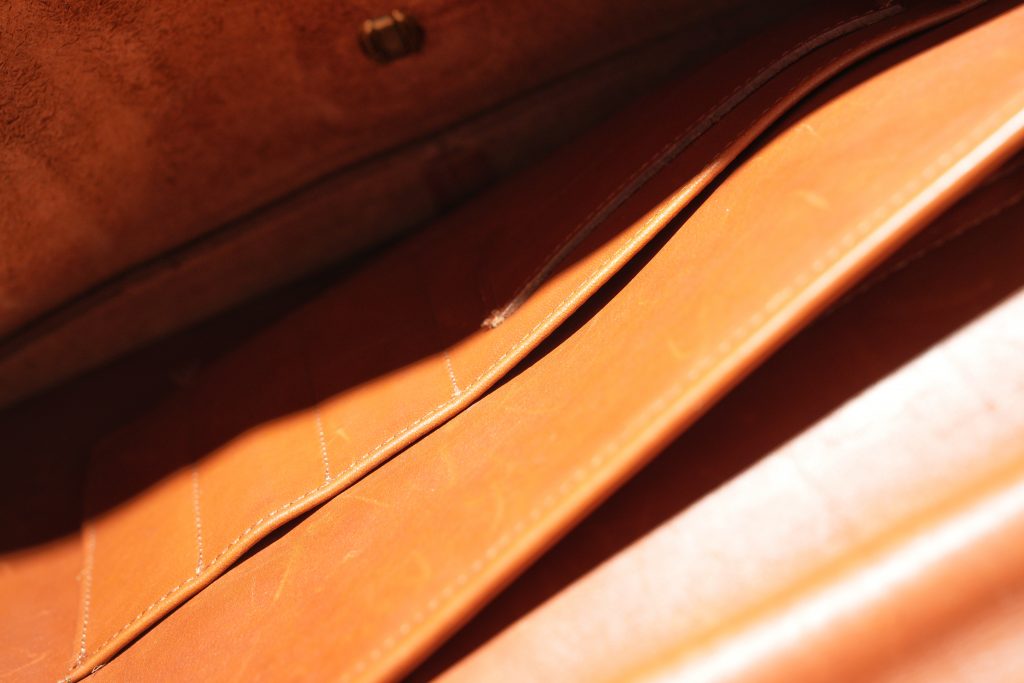 huge leather coach suitcase with pen holding pockets